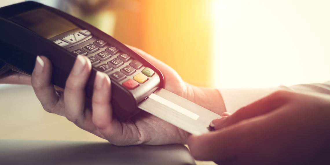 Close-up of a person using a credit card payment system