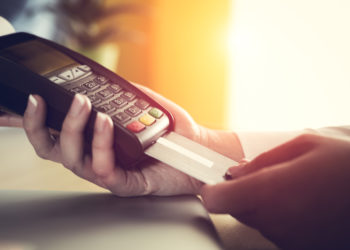 Close-up of a person using a credit card payment system